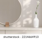 3D render close up beautiful flower in a white bottle on modern beige dressing table with round mirror by the window with morning sunlight and foliages leaves shadow on the wall. Empty space, Blank.
