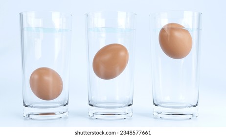 3D render of Egg in water test on transparent glass, Egg freshness test on white background, Bad egg floats in water 
