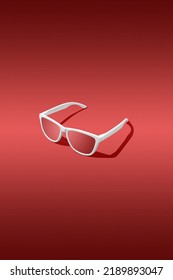 3D Render Of Red Sunglasses With Red Gradient Background. Studio Shot.