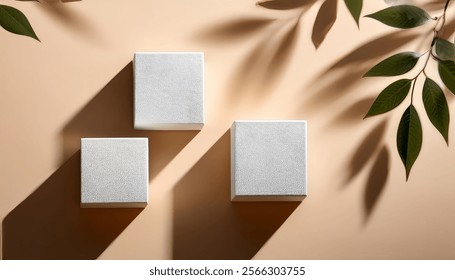 3D render of Three white cubes of different sizes on a beige surface with leaf shadows on the wall.