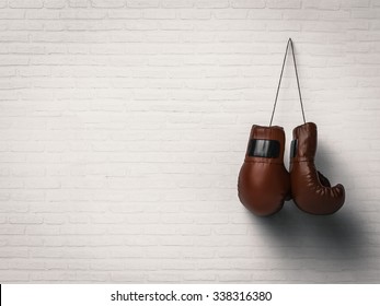 3d Rendered Boxing Gloves Hanging On White Brick Wall Background