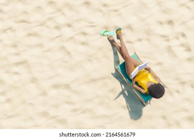 3D rendering aerial view of unrecognizable African American female tourist with curly hair in yellow swimsuit relaxing on lounger and reading interesting book on sunny day on sandy beach - Powered by Shutterstock