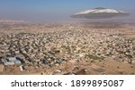3D rendering, Alien Spaceship ufo hovering over city in the desert - aerial view
, drone view over Jericho city in Palestine with visual effect element, invasion sci fi concept
