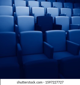 3d rendering auditorium with one reserved seat toned in trendy Classic Blue color of the Year 2020