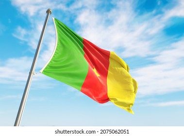 3d rendering Cameroon flag waving in the wind on flagpole. Perspective wiev Cameroon flag waving a blue cloudy sky