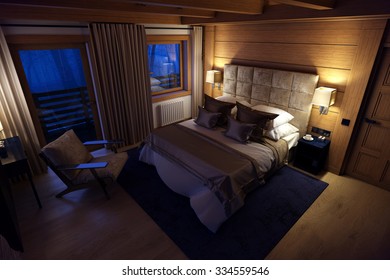 3D rendering cozy bedroom is in the attic of a chalet. Huge bed with numerous pillows is dominates the room. The interior is decorated with wood and natural materials.
