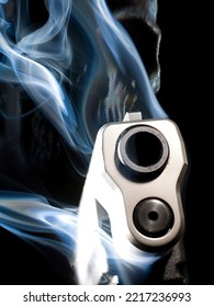 3D Rendering Of A Ghost Gun With Smoke Rising From The Barrel And Skull Behind On A Black Background