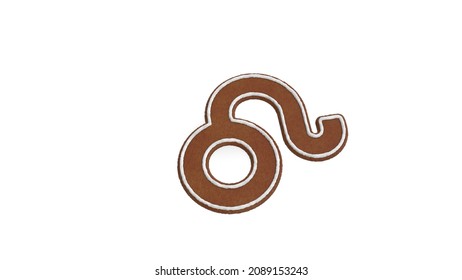 3d rendering of gingerbread cookie in shape of symbol of Leo zodiac horoscope isolated on white background with white icing