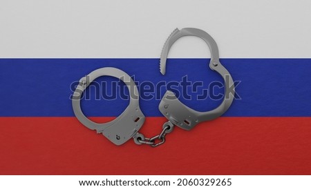 3D rendering of a half opened steel handcuff in center on top of the national flag of Russia