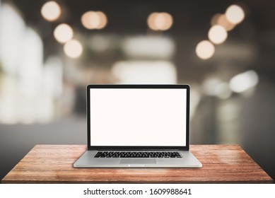 3D Rendering, laptop on wooden table with blur background