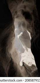 3D rendering  Light at the end the tunnel through the rock  A cave in the mountain and an exit at the end 