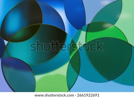 3D rendering of Overlapping Transparent Green and Blue Glass Discs Creating Soft Abstract Patterns on a Light Background