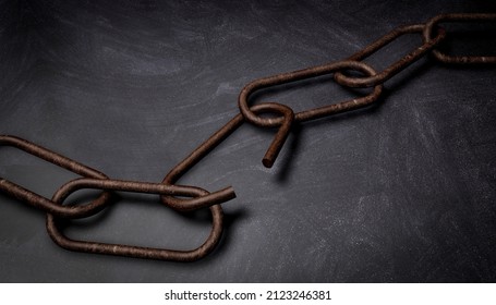 3D rendering rusty broken chain, on dark stone background