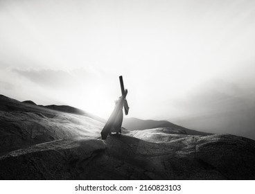 3D rendering - The sky over Golgotha hill shrouded in majestic light and clouds, Jesus Christ carrying the suffering cross symbolizing death, sacrifice and resurrection