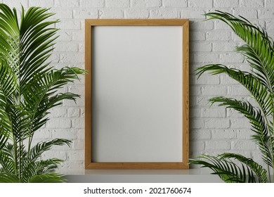 3d rendering of a standard 24 x 36 inch standing with canvas paper for poster or artwork mockup with walnut wood frame on the white clean surface in minimal cozy natural white brick interior