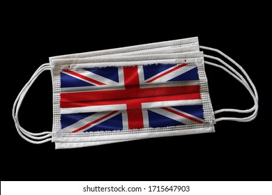 3D Rendering Of Surgical Face Masks With UK Flag Printed. Isolated On Black Background. Concept Of Face Mask Usage In The British Effort To Combat Covid-19 Coronavirus Pandemic. Illustration.