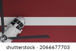 3D Rendering of a top down view of a White Helicopter in the Bottom Left Corner and on top of the National Flag of Latvia