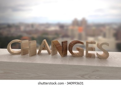 3d rendering of the word changes over a wooden surface
