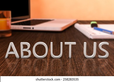About us - letters on wooden desk with laptop computer and a notebook. 3d render illustration.