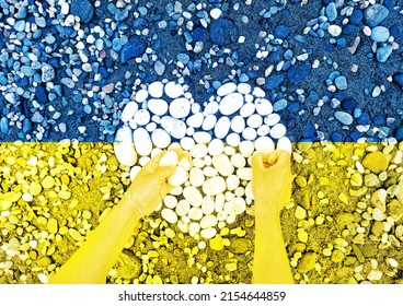 Abstract Art, Blue And Yellow Design Of Stones. Ukraine Flag Colors. Woman Hands Creating Love And Heart Shape.