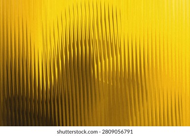 An abstract background composed of vertical parallel lines, creating a sharp, ridged texture with bright yellow highlights and dark brown shadows.