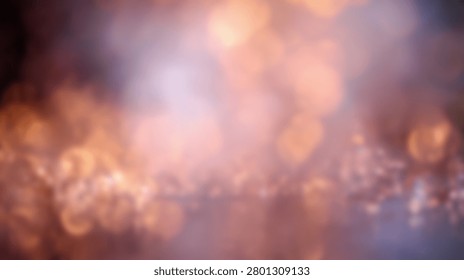 Abstract background with soft focus bokeh lights and swirling smoke effect in warm tones of orange, pink, and purple.