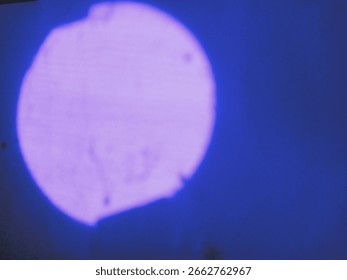 Abstract Blue Light Image, This image features an abstract representation of a large circular area illuminated in vibrant blue and purple hues.