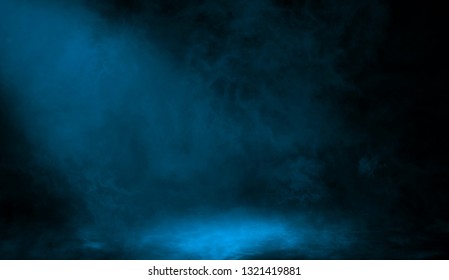 Abstract Blue Spotlight With Smoke Mist Fog On A Black Background. Texture Background For Graphic And Web Design.