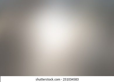 Abstract blur gray background with white light in the middle
