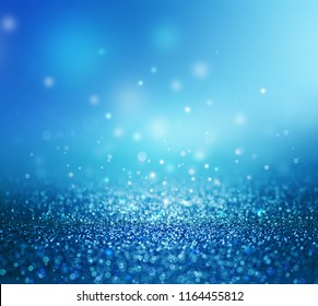 Abstract bokeh background of blue sparkle glitters and light texture.