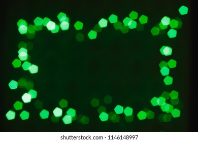 Abstract bokeh lights with soft light background. Green Christmas frame with copy space.