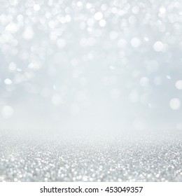 Abstract Of Bright And Sparkling Bokeh Background. Silver And Diamond Dust Bokeh -blurred Lighting From Glitter Texture. Luxury Design Background.