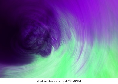 Abstract circular motion blurred background in purple cyan green