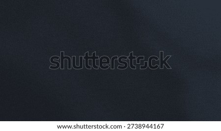 Abstract close-up of a dark textured surface with subtle lighting variations