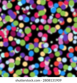 Abstract colorful dots pattern on dark black background. Vibrant blurry circles bokeh texture for celebration and festive design.