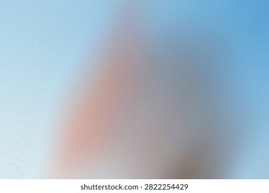 An abstract composition with a soft blend of blue and peach hues, characterized by a subtle grainy texture that adds depth and a dreamlike quality.