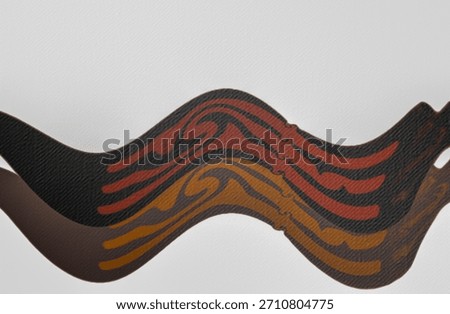 abstract composition of wavy layers of material with patterns in warm tones