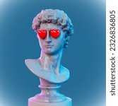 Abstract concept illustration from 3D rendering of white marble classical male bust with emoticon style red heart shaped eyes on blue background.