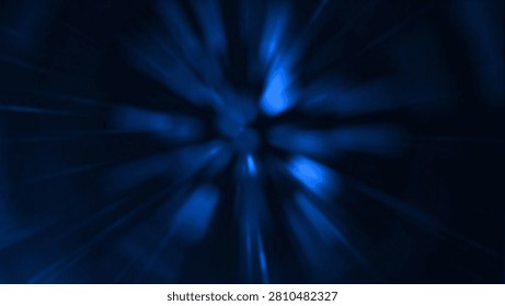 Abstract dark background featuring a blue radial burst light ray pattern radiating from the center