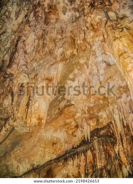 Abstract\
drawing of an underground cave with stalactites and stalagmites.\
Limestone karst formation. Travel and vacation concept. Digital\
painting. Abstract naturalism, relief\
pattern.