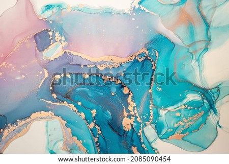 Abstract fluid art painting background in alcohol ink technique, mixture of magenta, purple and blue paints. Transparent overlayers of ink create glowing golden veins and gradients.
