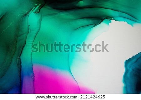 Abstract fluid art painting background in alcohol ink technique, mixture of magenta, purple and green paints. Transparent overlayers of ink create veins and gradients.