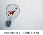 Abstract glowing lamp with drawn space ship. Startup and entrepreneurship texture. 3D Rendering 