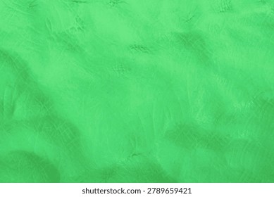 Abstract green modeling clay texture background.
Plasticine meets the boundless joy of childhood.  top view