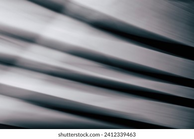 Abstract horizontal striped background with smooth lines and highlights in black and gray tones. Backdrop