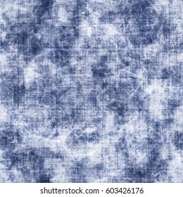 Abstract indigo tie-dyed and acid-washed fabric textured background. Seamless pattern.