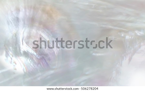 Abstract pearl background with shimmering mother\
of pearl lilac and rainbow\
colours