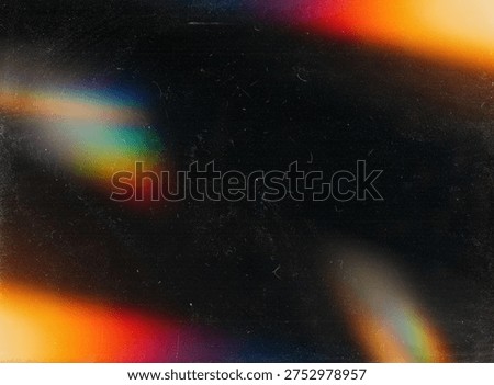 Abstract rainbow light leak effect on dark grainy film texture