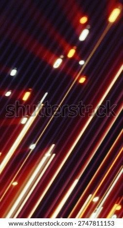 Abstract red and orange diagonal light streaks creating a sense of speed, motion, and futuristic energy flow.