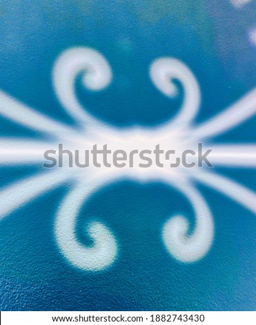 Abstract representation in white with circular and rectilinear shapes on a blue background